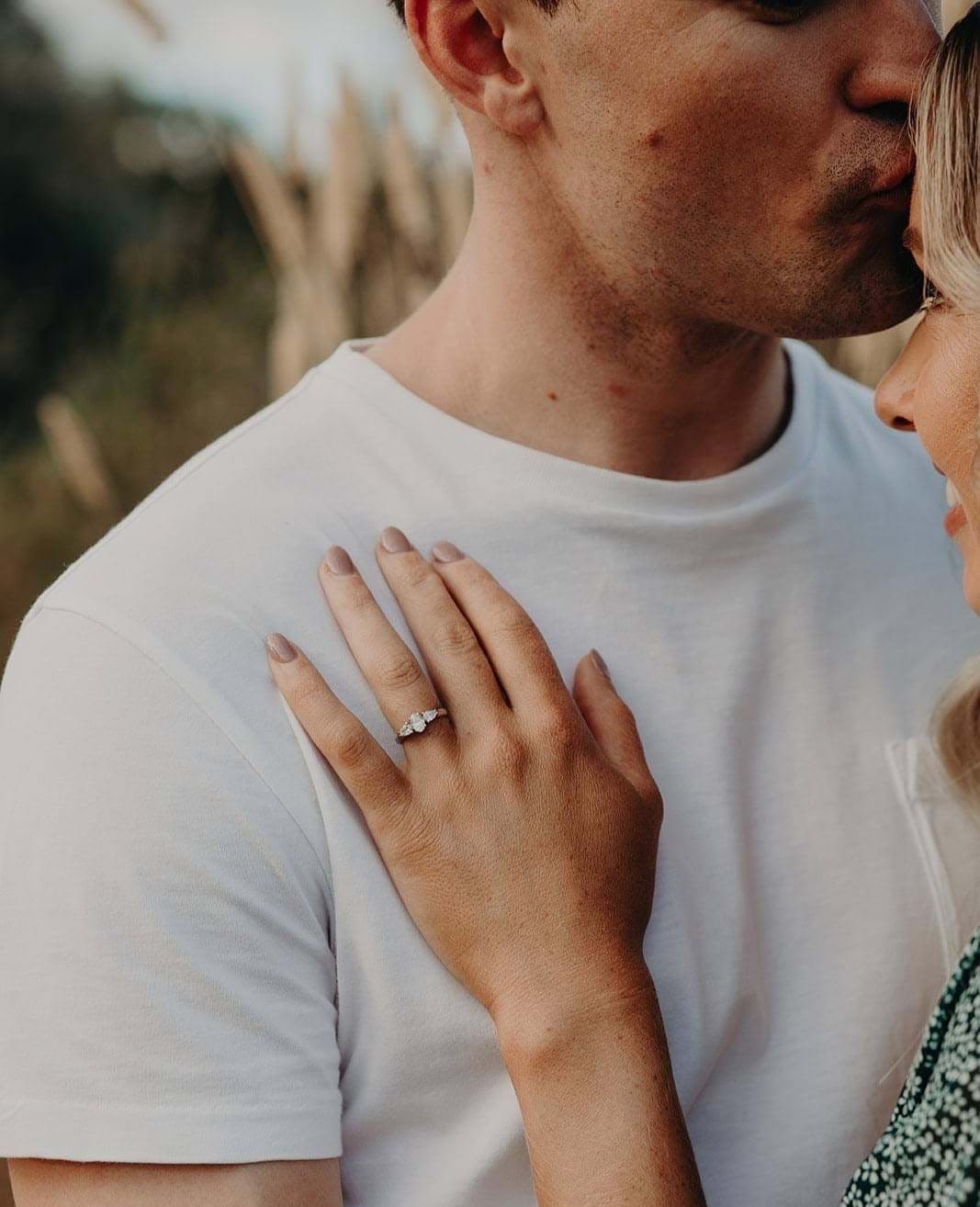 Happy couple with diamond engagement ring with centre oval diamond and side pear diamonds in white gold, Melbourne, Eltham jeweller, Australia