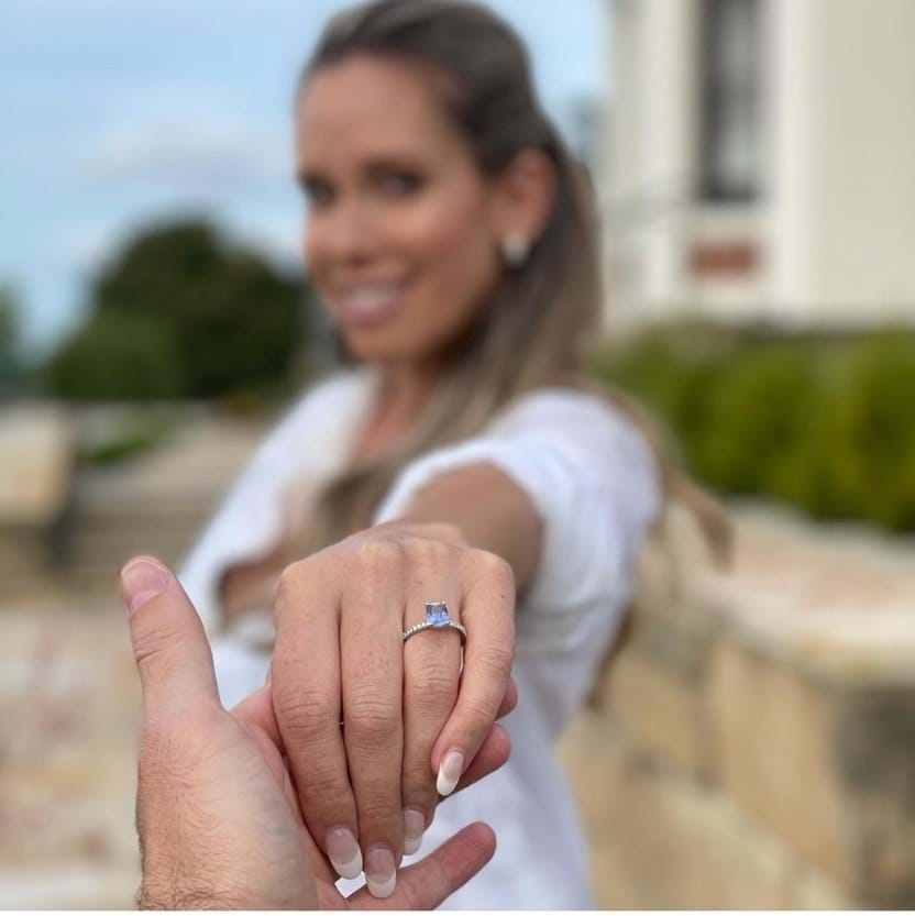 Happy woman with engagement ring, blue sapphire solitaire, Melbourne, Eltham jeweller, Australia
