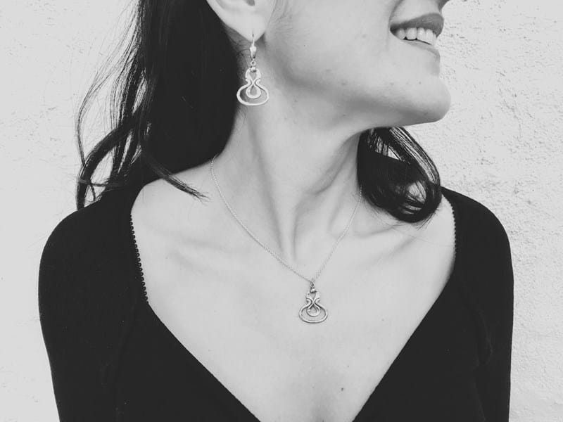 Model wearing jewellery, Desborough mirror pendant in sterling silver and matching earrings, jewellery, Melbourne Australia