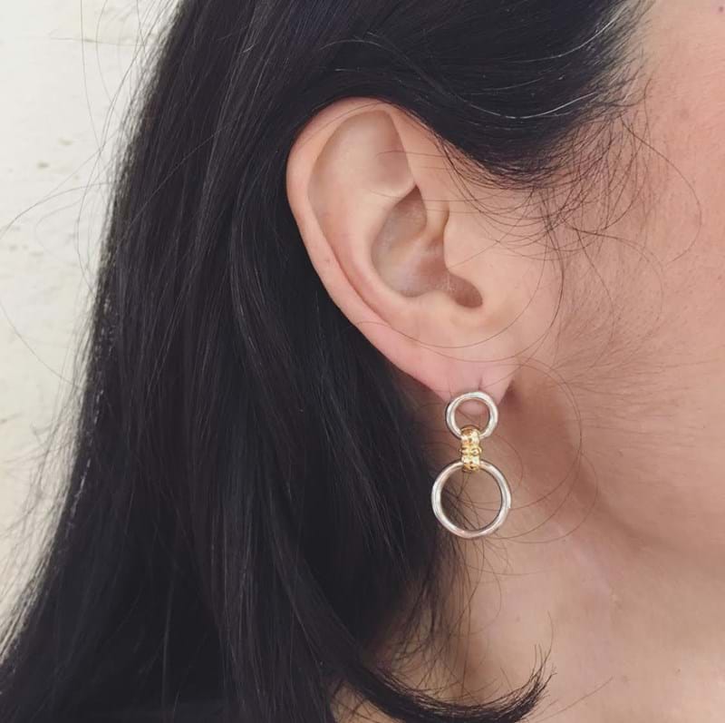 Circlet two-tone earrings in yellow gold and sterling silver on model, Melbourne Australia