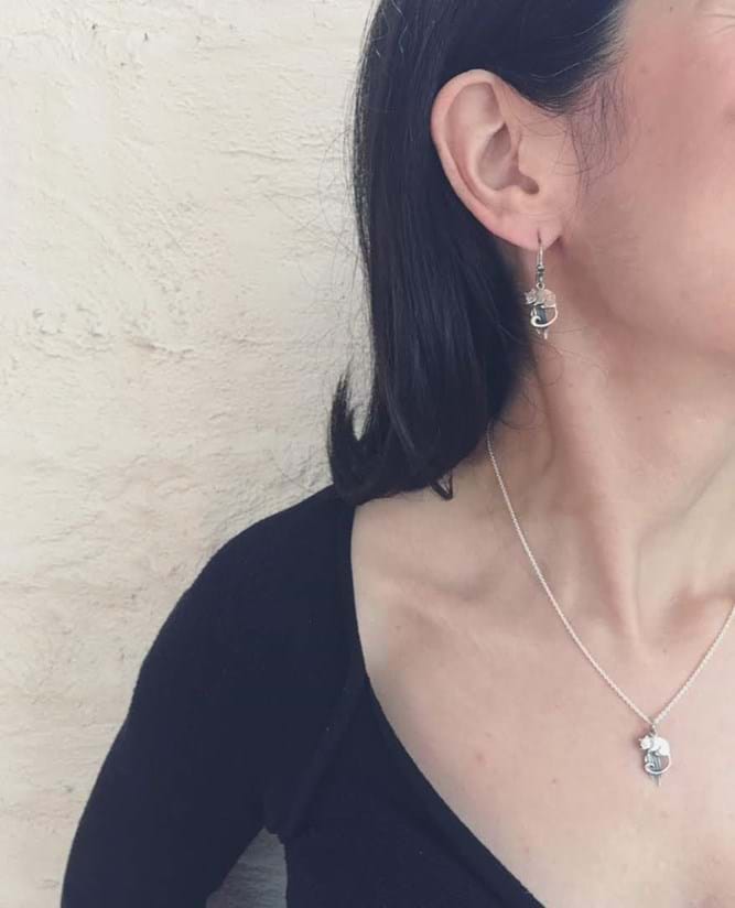 Model wearing handcrafted leadbeater's possum earrings and matching pendant on chain in sterling silver, jewellery, Melbourne, Australia, souvenirs
